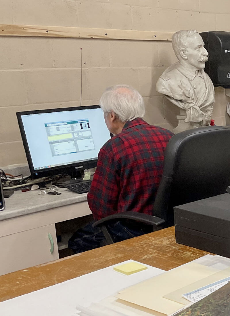 Volunteer at T. W. Wood Gallery working on computer