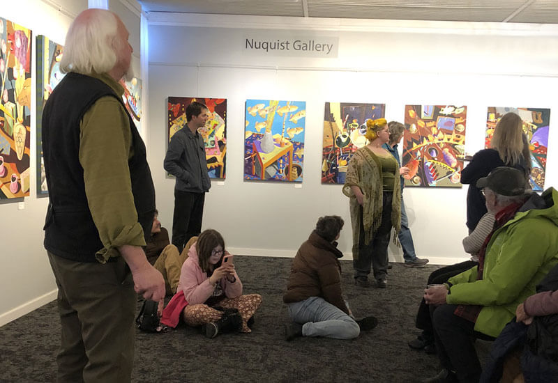 People viewing art in the Nuquist Gallery at T.W. Wood