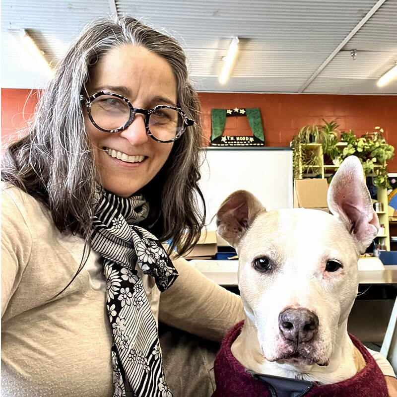 A smiling woman with a dog