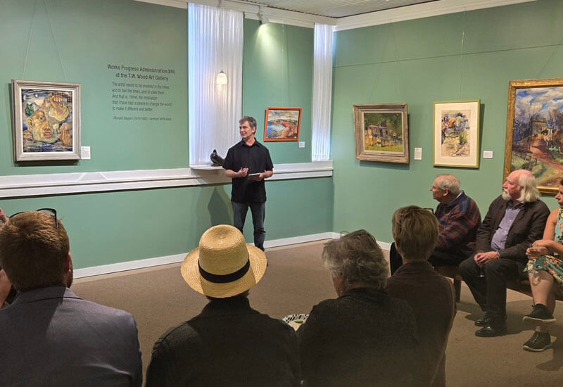 A man talking about art at the T.W. Wood Museum
