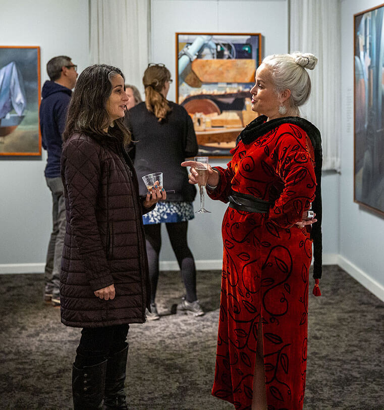 People talking at an event at T.W. Wood Museum