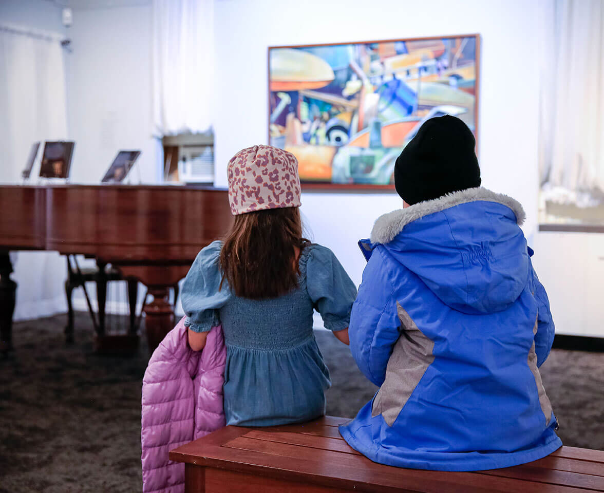 Two young girls looking at art at the T.W. Wood Museum